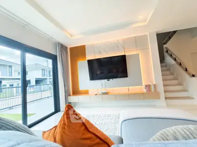 Modern living room with stylish TV setup and large window view