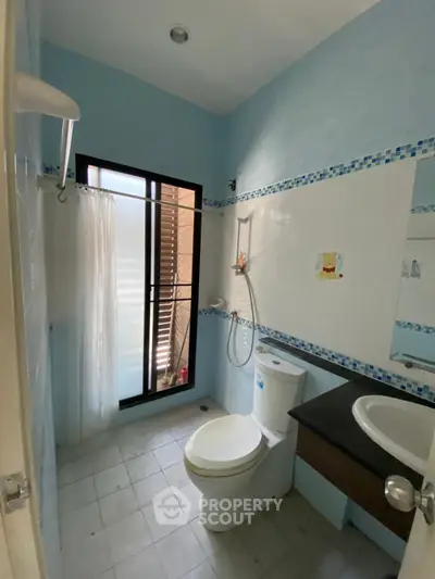 Charming bathroom with modern fixtures and natural light, perfect for a cozy home.