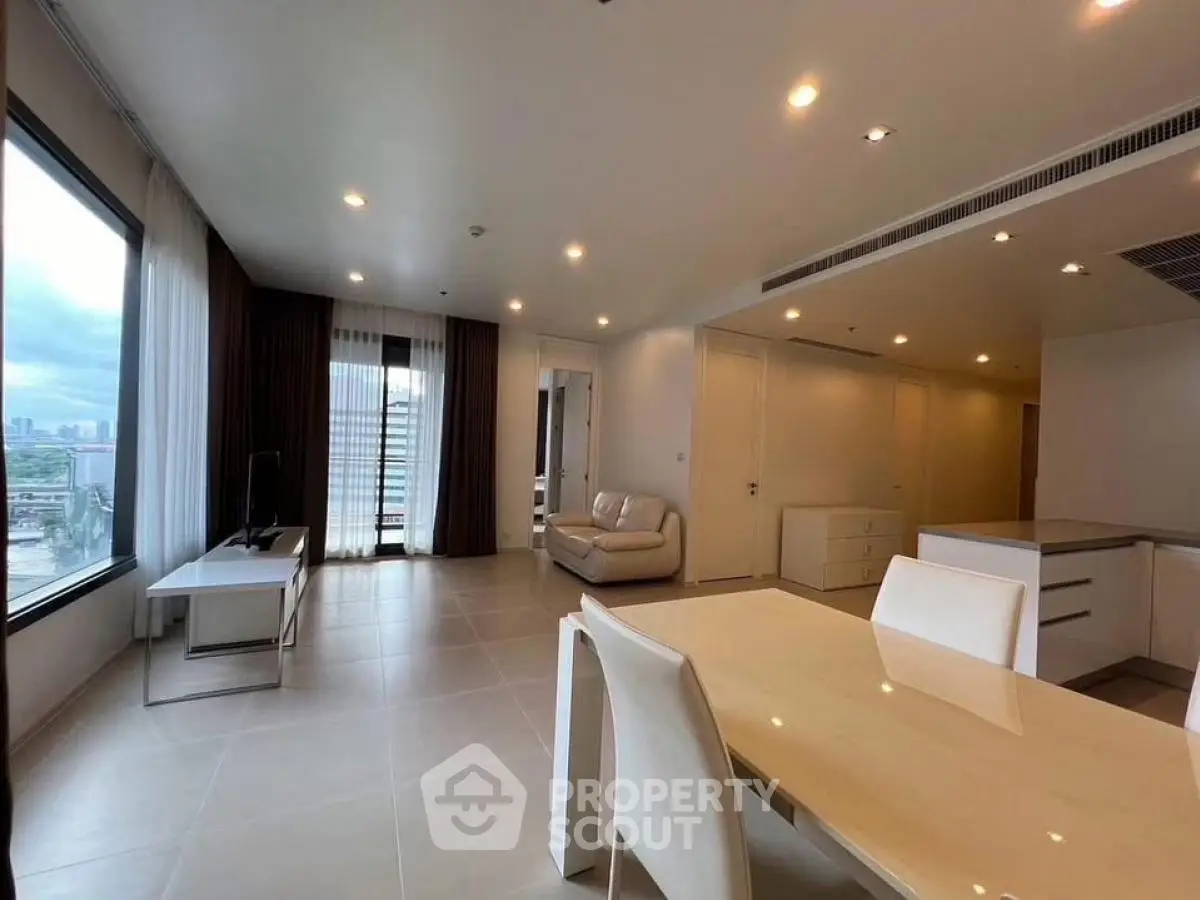 Spacious modern living room with city view and elegant dining area