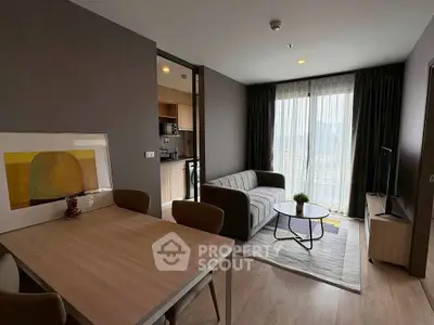 Modern living room with open kitchen and stylish decor in a cozy apartment.