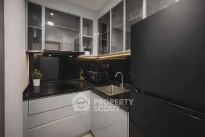 Modern kitchen with sleek black countertops and built-in appliances