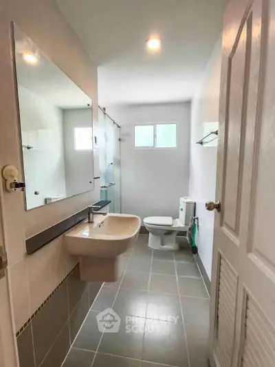 Modern bathroom with sleek fixtures and spacious shower area.