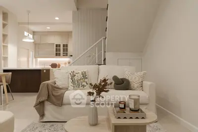 Stylish living room with cozy sofa, modern decor, and open kitchen layout