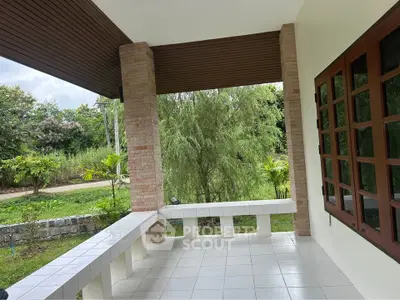 Charming patio with lush garden view and elegant tiled flooring.
