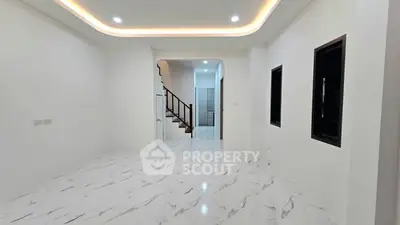Spacious modern living room with elegant marble flooring and ambient lighting