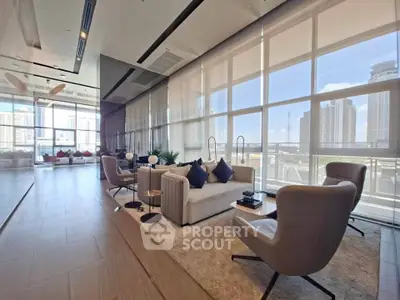 Luxurious modern living room with floor-to-ceiling windows and city skyline view.
