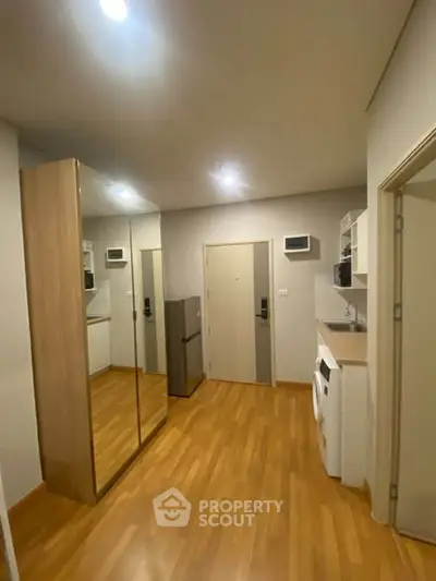 Modern apartment interior with mirrored closet and wooden flooring