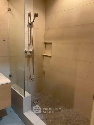 Modern bathroom with sleek shower design and neutral tiles