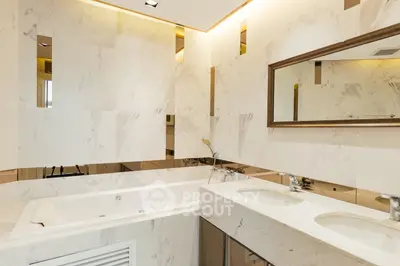 Luxurious bathroom with marble finishes and dual sinks