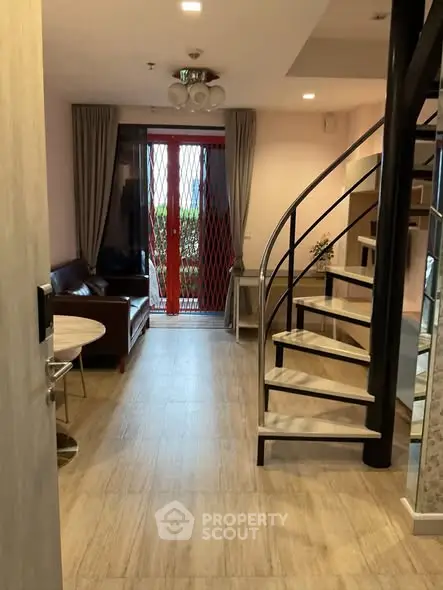 Chic duplex living room with spiral staircase and modern decor