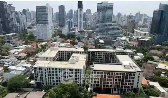Stunning aerial view of modern cityscape with high-rise buildings and lush greenery.