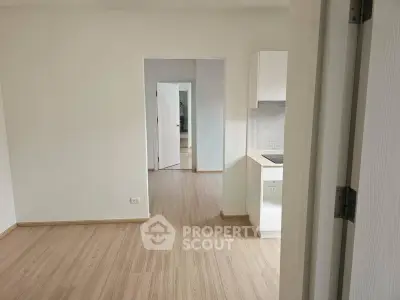 Spacious modern apartment interior with open layout and sleek wooden flooring.