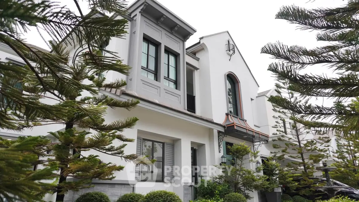 Elegant modern house exterior with lush greenery and stylish architectural design.