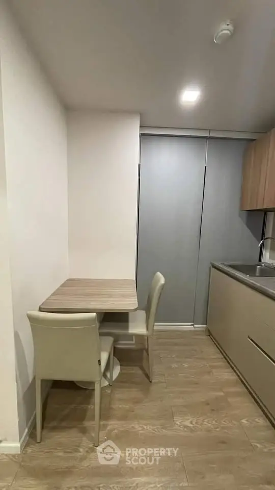 Modern compact kitchen with sleek design and cozy dining area