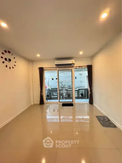 Spacious living room with modern design and large windows for natural light.