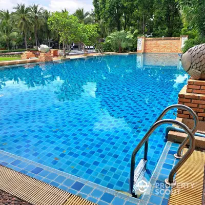 Luxurious outdoor swimming pool with lush greenery and serene ambiance