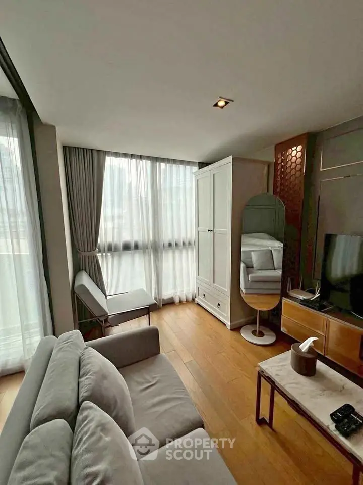 Modern living room with stylish furniture and large windows in a contemporary apartment.