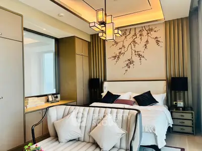 Luxurious bedroom with elegant decor and modern lighting in a high-end apartment.