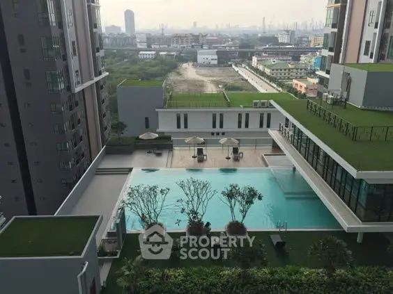 Luxurious rooftop pool with stunning city views in modern high-rise building.