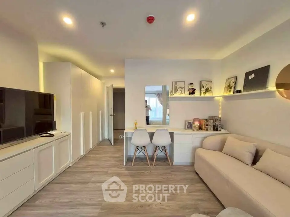 Modern living room with sleek design, cozy sofa, and stylish decor in a contemporary apartment.