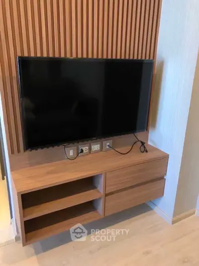 Modern living room with sleek TV unit and wooden paneling