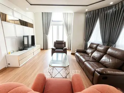 Spacious living room with modern furniture and large windows for natural light.