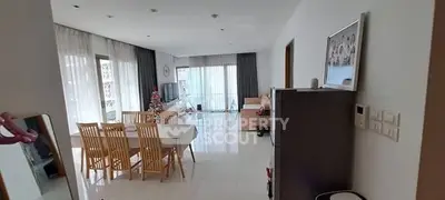 Spacious modern living room with dining area and large windows