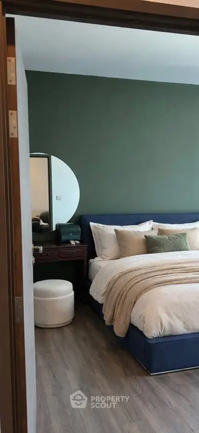 Modern bedroom with stylish decor and cozy bedding in a contemporary apartment.