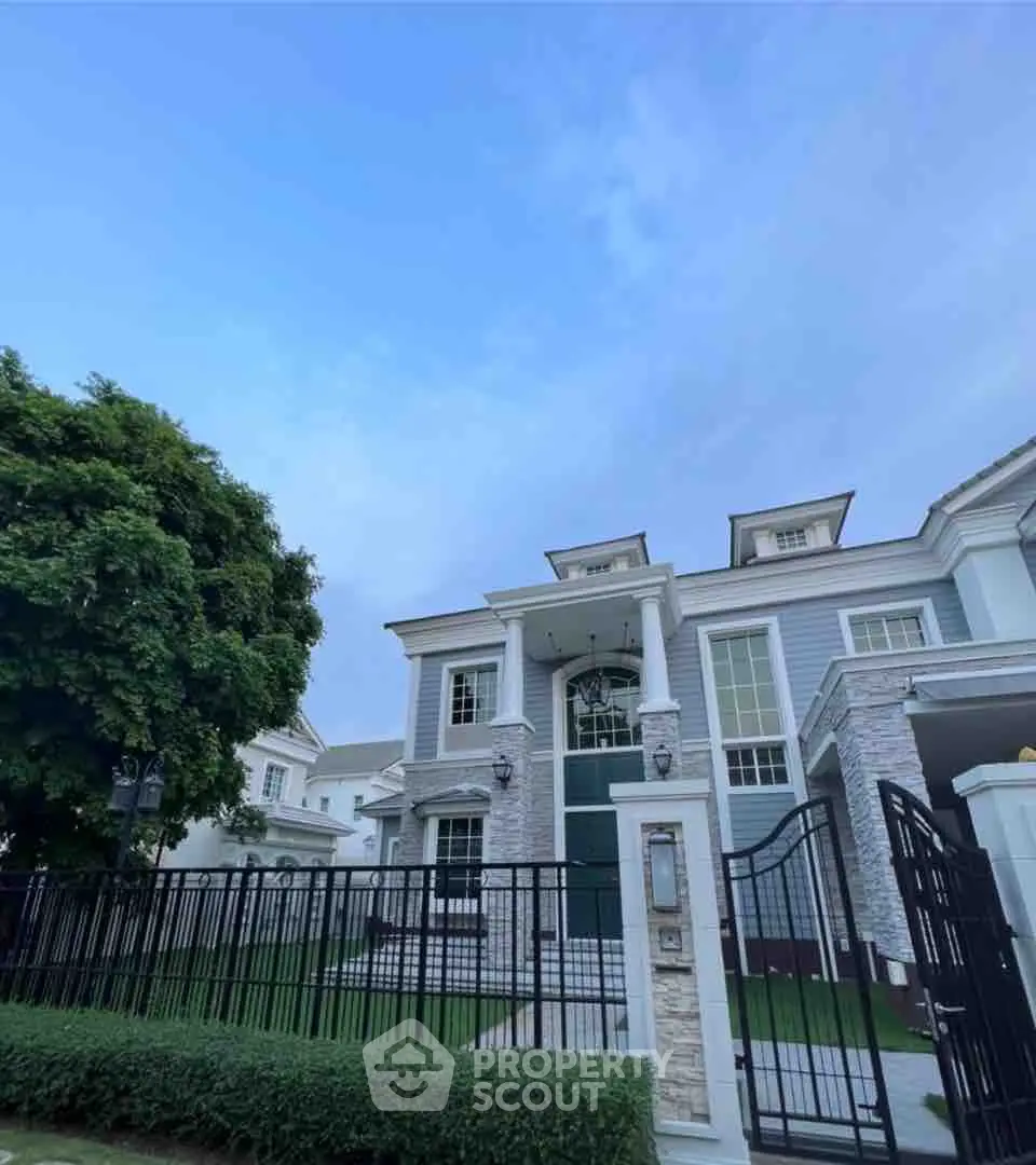 Elegant two-story house with lush garden and modern architecture