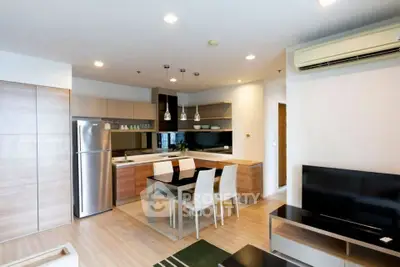 Modern open-layout kitchen and dining area with sleek appliances and stylish decor.