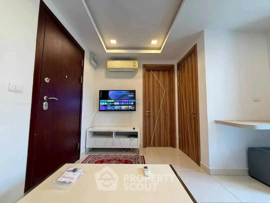 Modern living room with wall-mounted TV and sleek wooden doors