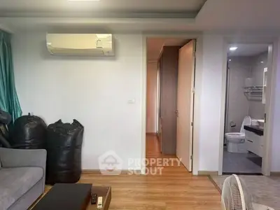 Modern living room with air conditioning and view into bathroom