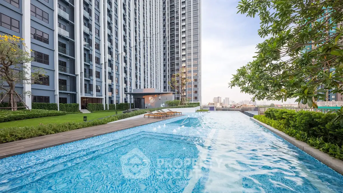 Luxurious high-rise apartment with stunning pool and city view, perfect for modern urban living.