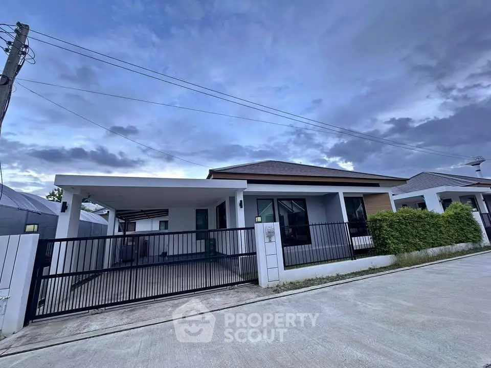 Modern single-story house with gated driveway and contemporary design