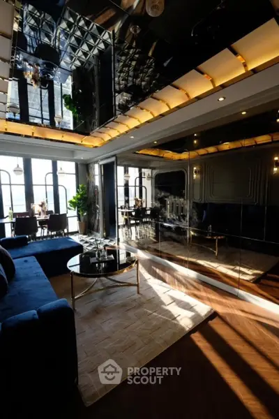 Luxurious modern living room with mirrored ceiling and elegant decor