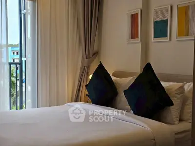 Cozy bedroom with modern decor and large window offering scenic views.