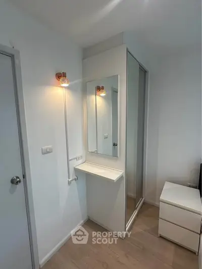 Modern bedroom with built-in closet and sleek vanity mirror