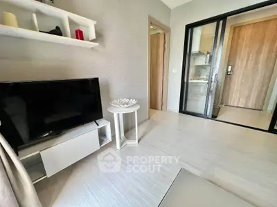 Modern living room with sleek TV setup and stylish decor in a contemporary apartment.