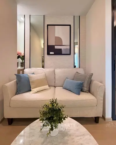 Cozy living room with elegant sofa and modern decor, perfect for relaxation and style.