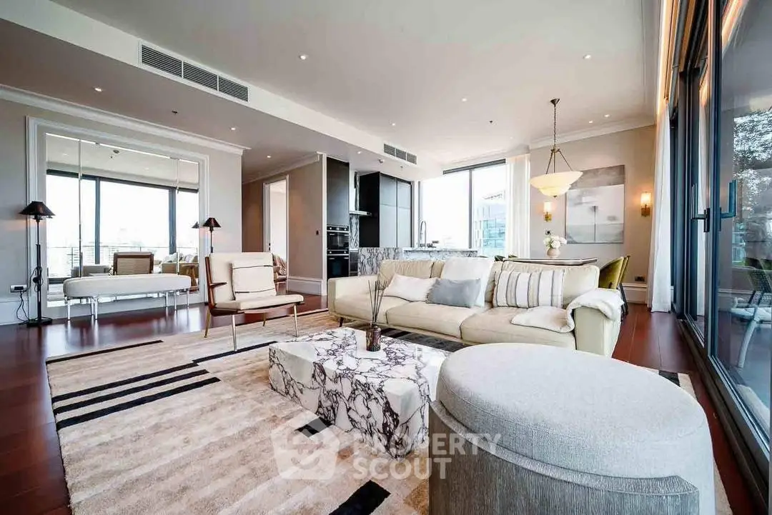 Luxurious open-plan living room with modern decor and stunning city views.