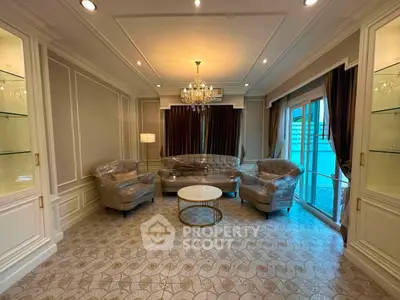 Luxurious living room with elegant chandelier and plush seating in a sophisticated setting.