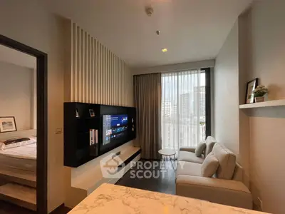 Modern living room with sleek design and city view, featuring a cozy sofa and wall-mounted TV.