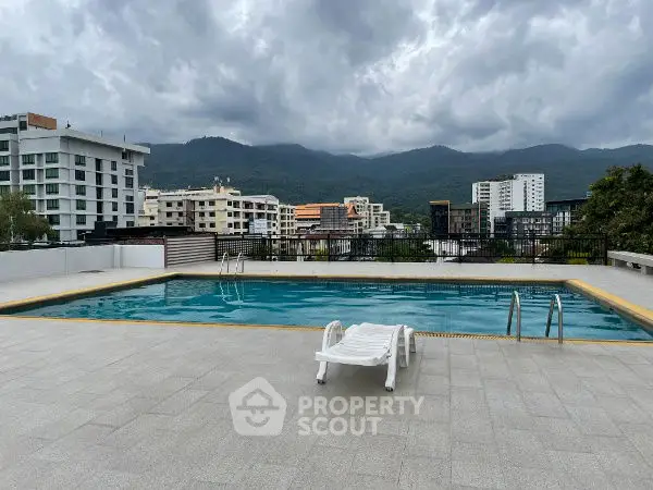 Stunning rooftop pool with mountain views in modern urban setting.