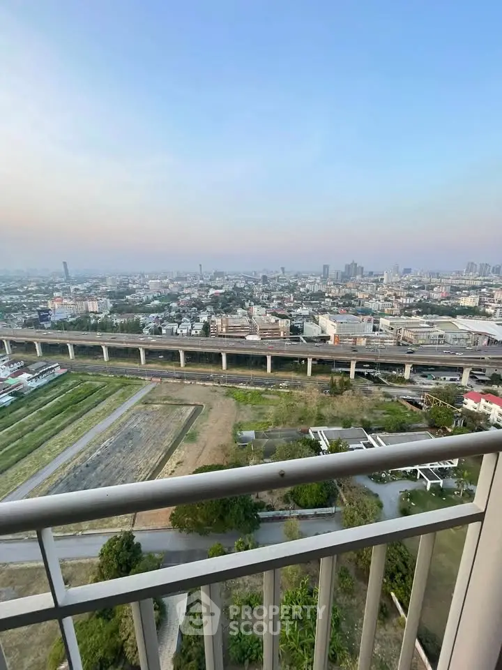 Stunning high-rise balcony view overlooking cityscape and greenery, perfect for urban living enthusiasts.