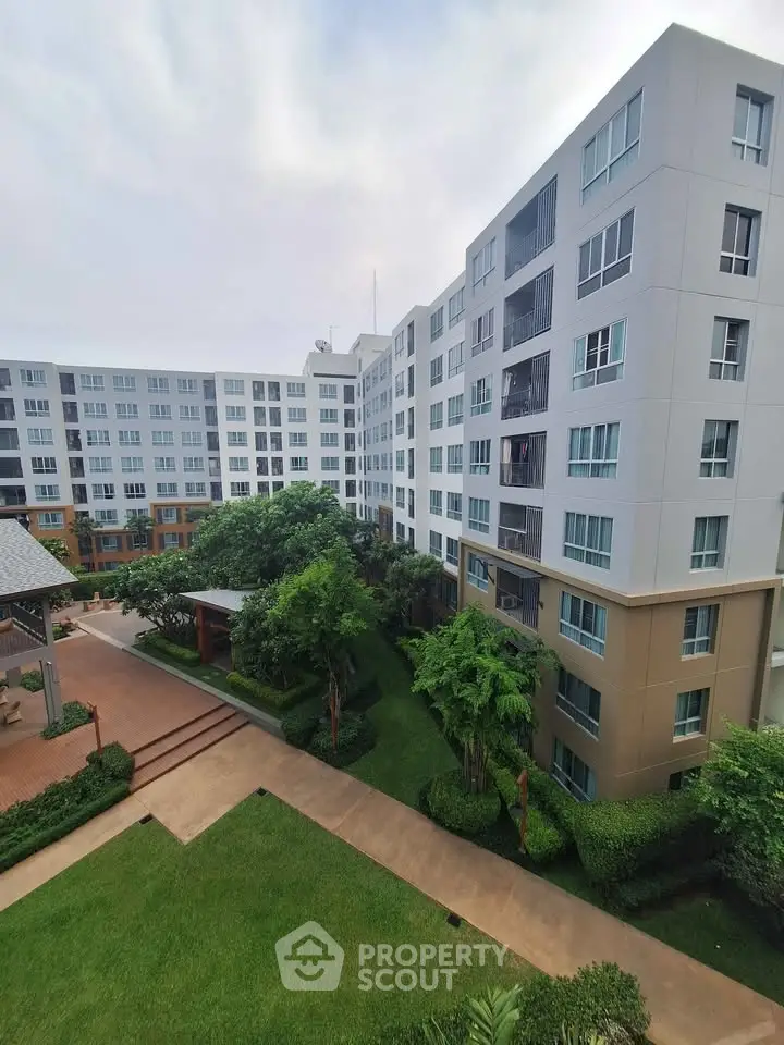 Modern apartment complex with lush garden and spacious outdoor area