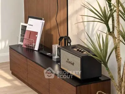 Stylish modern living room with sleek wooden cabinet and trendy decor accents.