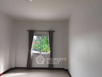 Spacious empty room with window view and natural light