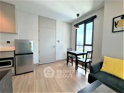 Modern apartment interior with cozy living area and dining space, featuring large window with city view.