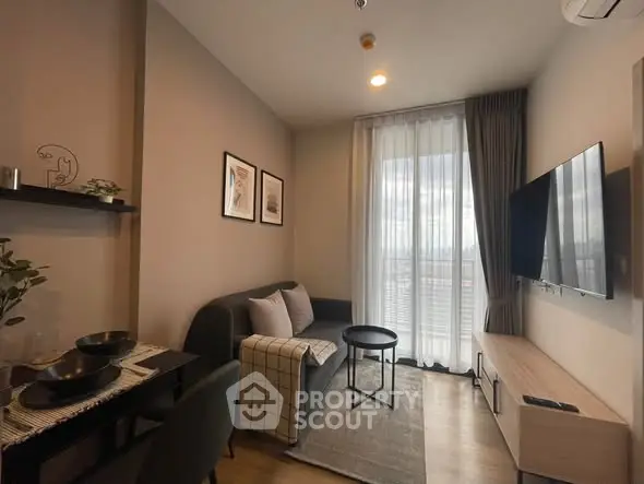 Modern living room with cozy sofa, wall-mounted TV, and elegant decor in a stylish apartment.