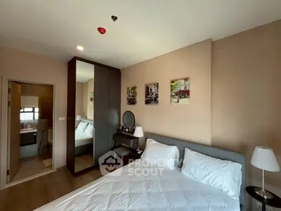 Modern bedroom with ensuite bathroom, stylish decor, and ample natural light.